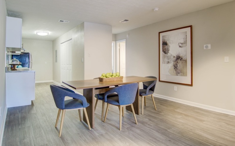 Large well lit living space with wood floors 