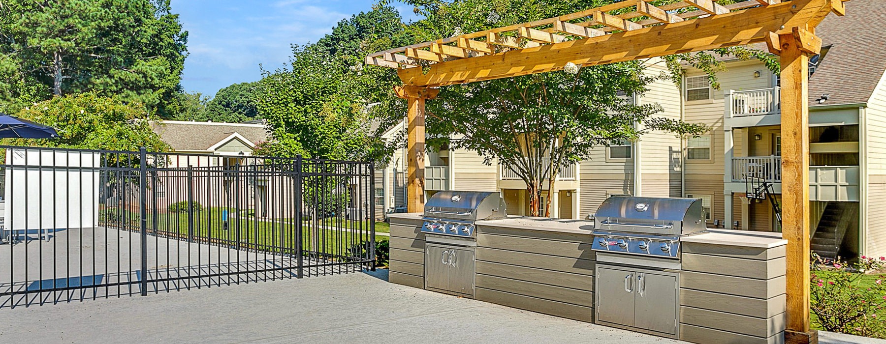 grills built into a cabinet under a pergola
