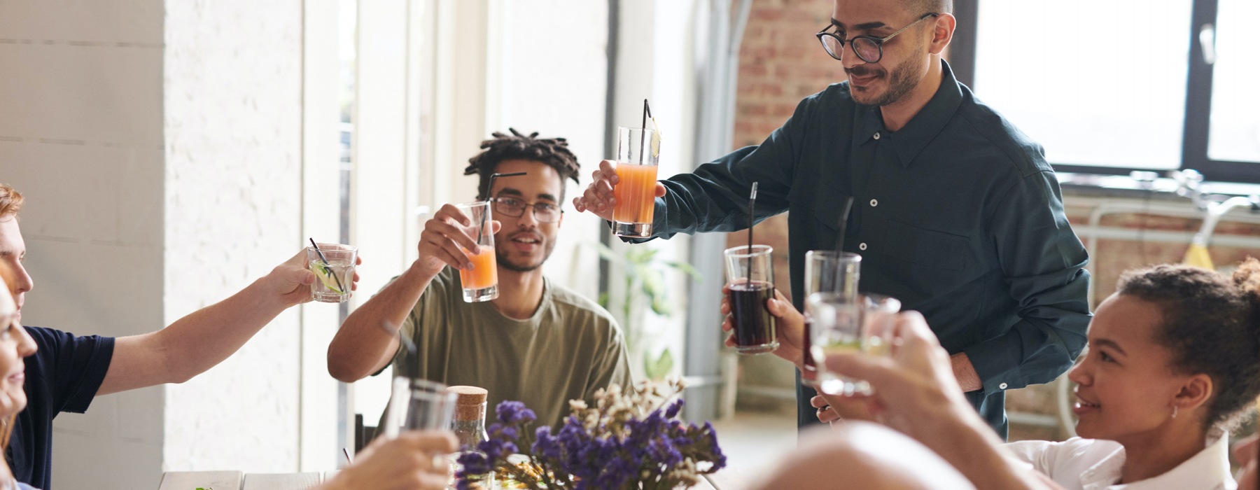 People toasting at dining table